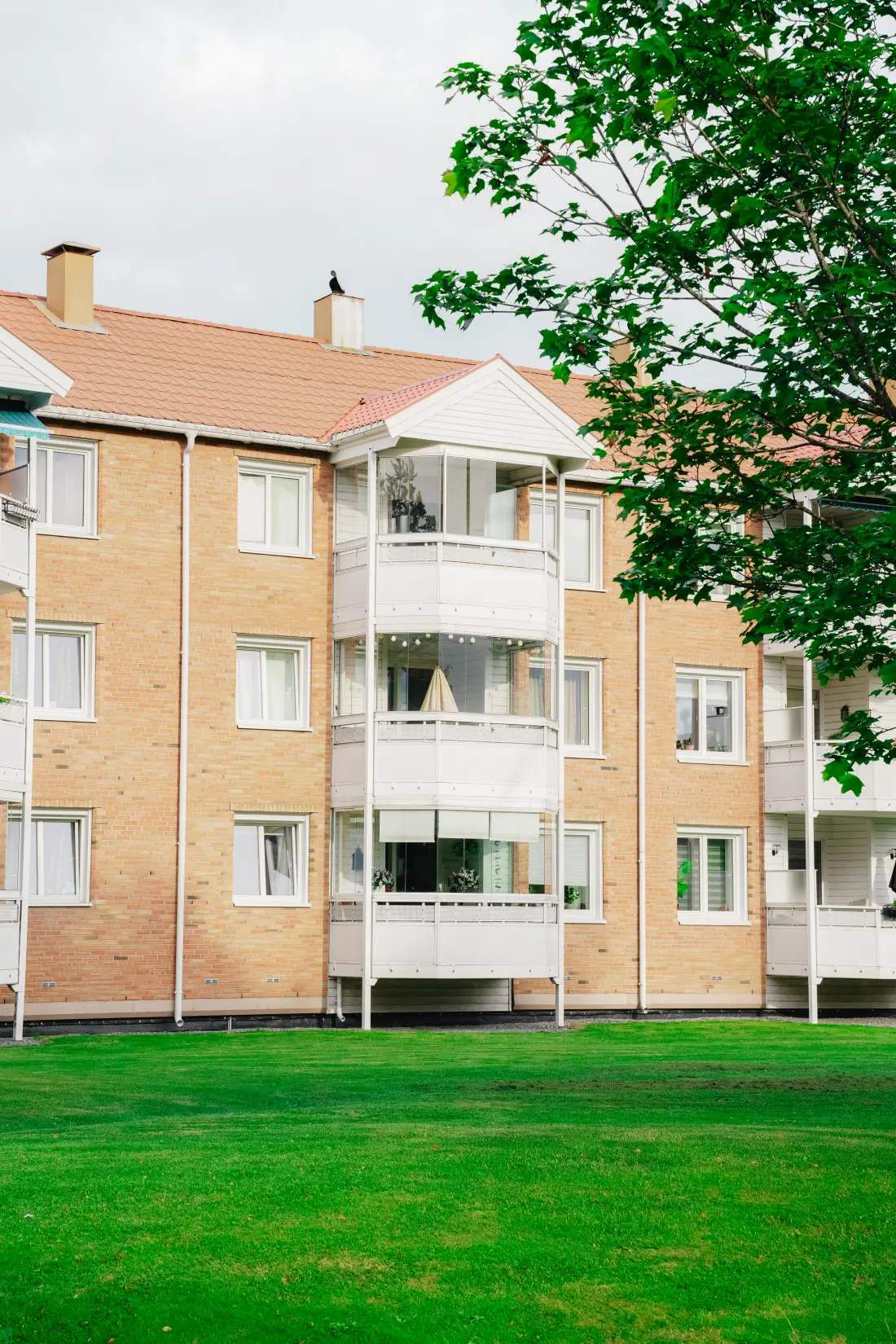 Rehabilitert boligblokk med lyse teglfasader og hvite balkonger